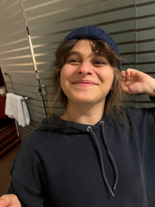 Photo of me showcasing a hat I knitted for my nephew